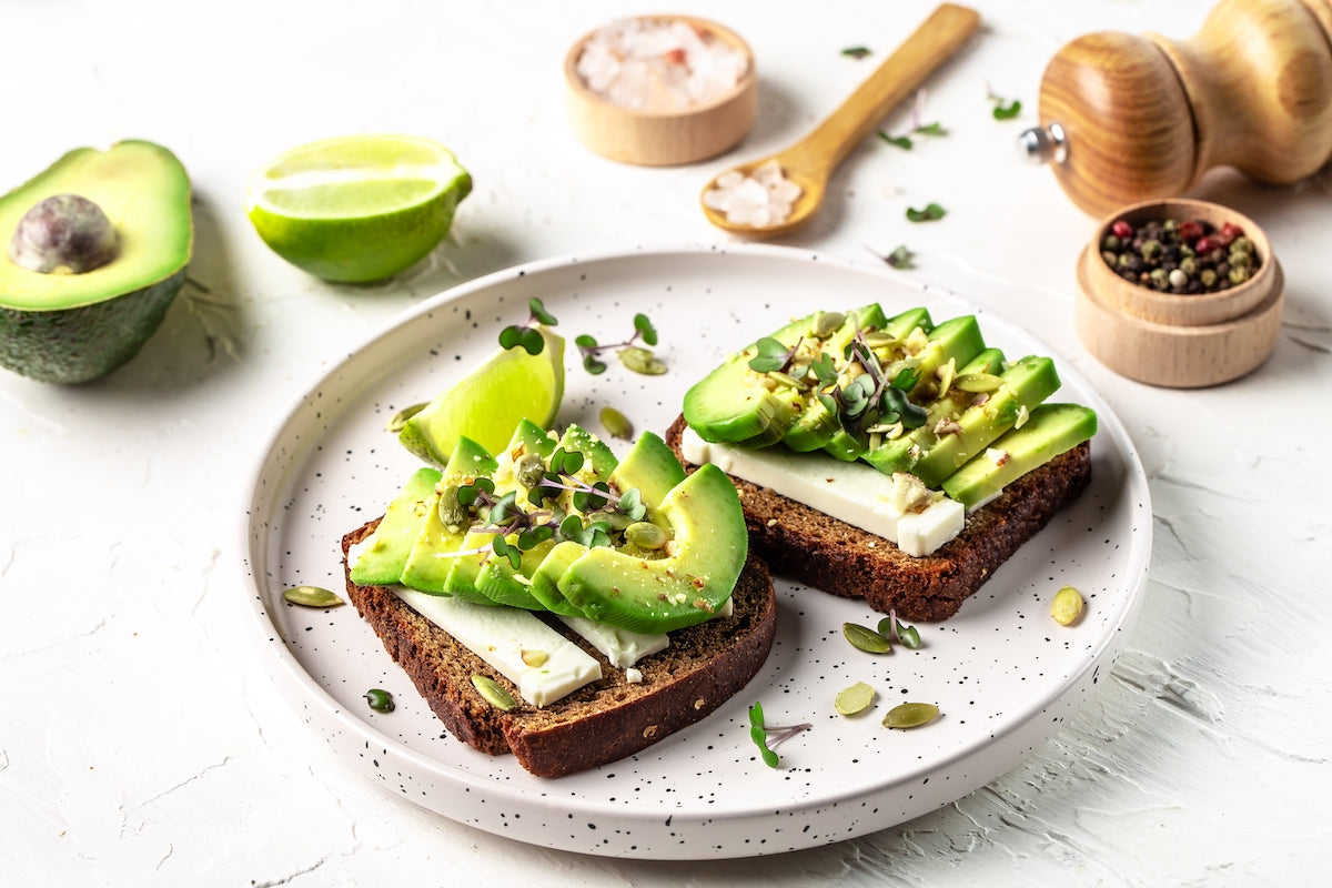 Gesunde Snacks für abends: Zwei Scheiben Brot mit Avocado auf einem Teller
